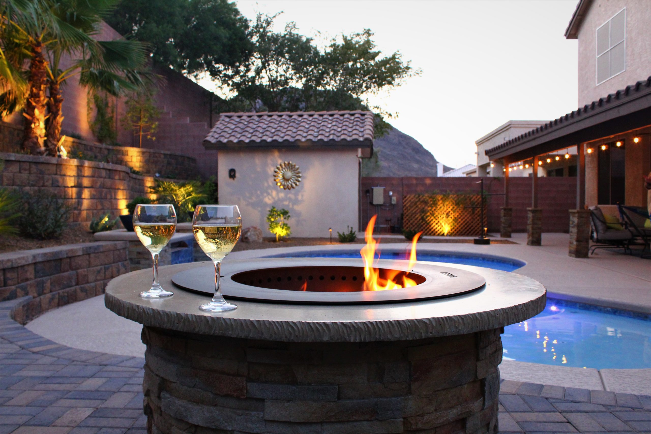 custom fire feature overlooking back yard landscaping